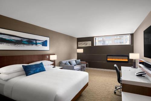 a hotel room with a large bed and a desk at Delta Hotels by Marriott Thunder Bay in Thunder Bay