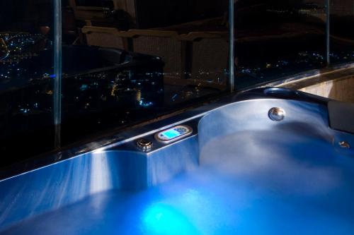 a hot tub with a view of a city at night at Bay Lodge Boutique Hotel in Jounieh
