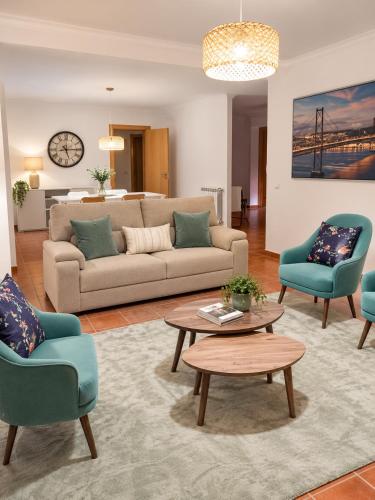 a living room with a couch and two chairs and a table at Casa com Alma by LovelyStay in Fátima