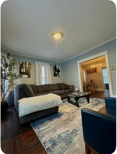 a living room with a couch and a table at Charming Cozy Getaway in Oneonta