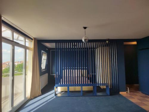 a blue bench in a room with a large window at The VIEW in Belgrade