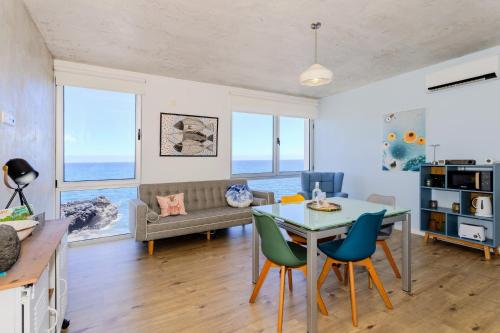 a living room with a table and chairs and a couch at GuestReady - Tranquil Oasis in Lagoa in Lagoa