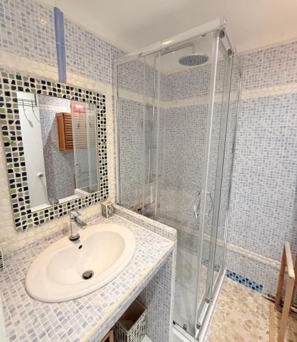 a bathroom with a sink and a shower at BlueDreamVacances Marines IV in Saint-François