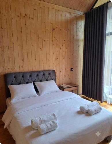 a bedroom with a large bed with two towels on it at AnArt rezort in Vanadzor