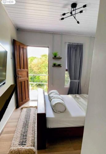 a small bedroom with a bed and a window at The Mountainstream Lodge in Lethem