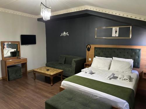 a hotel room with a bed and a couch at Riwaner Hotel in Avcılar