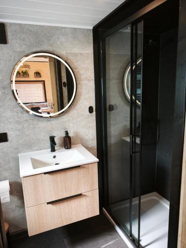a bathroom with a sink and a mirror at Tiny Vinkel - Domki Tiny House Jastarnia in Jastarnia