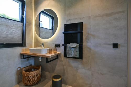 a bathroom with a sink and a mirror at Bij Corine, bed en zorg in Altforst