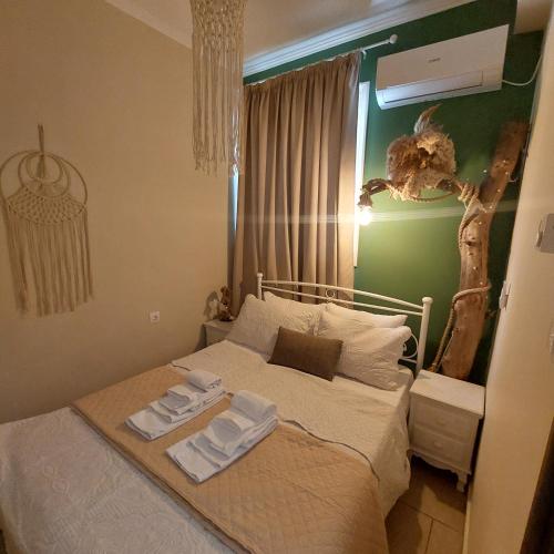 a bedroom with a bed with two towels on it at The Mastiha Spot 1 in Chios