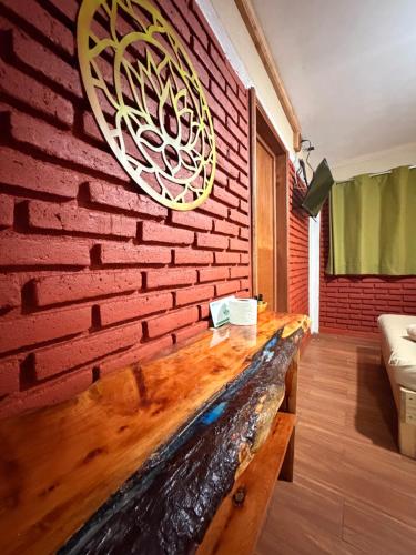 a brick wall with a wooden table in a room at Hotel Spa Chignahuapan Mágico in Chignahuapan