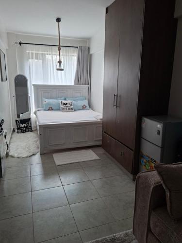 a small bedroom with a bed and a window at Luna Homes at Tsavo Sunset, Kiambu Road in Kiambu