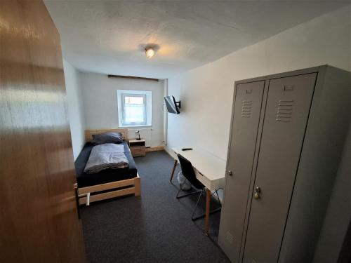 a bedroom with a bed and a desk and a bed sidx sidx sidx at Zum oid'n Leidlhof in Berching