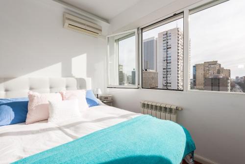 a bedroom with a bed with a view of a city at General Peron Picasso in Madrid