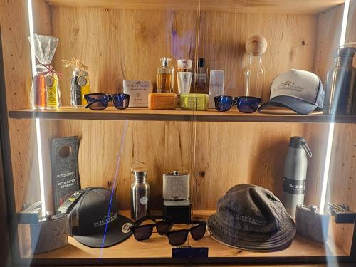 a wooden shelf with glasses and bottles on it at modern&renovated - Hotelpension Oberauer Wagrain in Wagrain