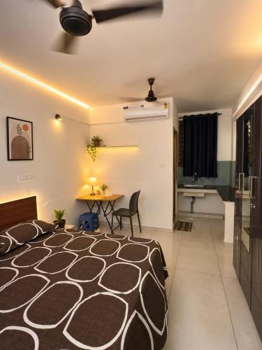 a bedroom with a bed and a table in a room at K K Residency in Alwaye