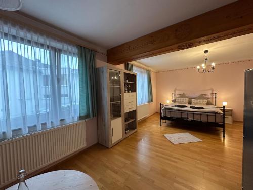 a bedroom with a bed and a large window at Max and Moritz Top 9 in Liebenau