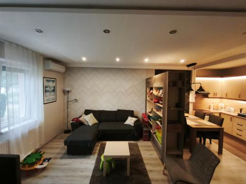 a living room with a couch and a table at Family Residence in Eger
