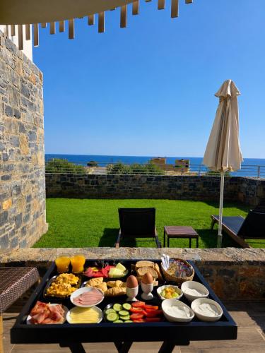 a tray of food on top of a table with food at Theasea Stylish Residences in Panormos Rethymno