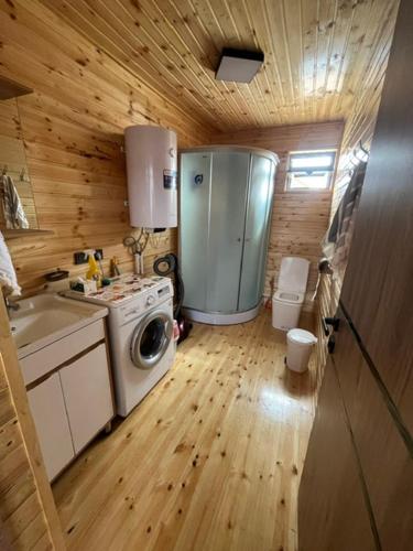 a small kitchen with a washing machine and a sink at Barnhouse in Bosteri