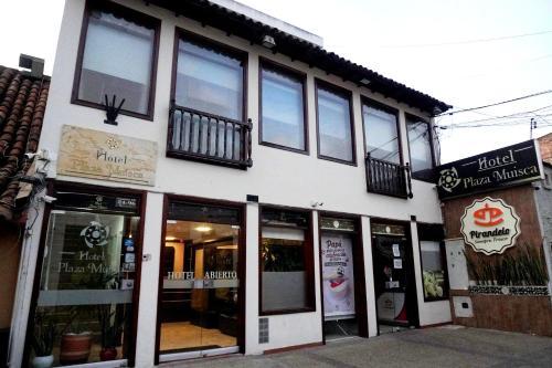 a store front of a building with windows at Hotel Plaza Muisca in Tunja
