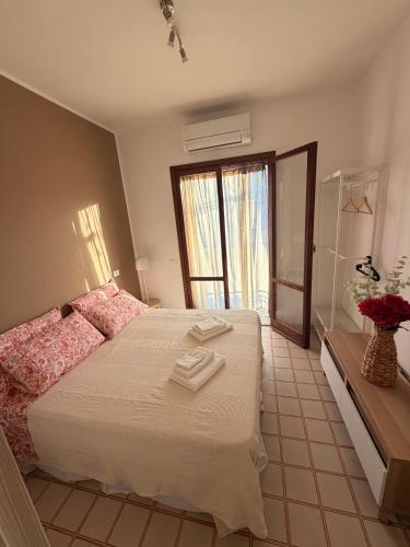 a bedroom with a bed with two towels on it at Casa DeA in Giardini Naxos