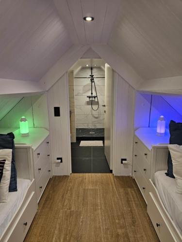 a bathroom with two beds and a shower in it at Les Terrasses de Laloux in Rochefort