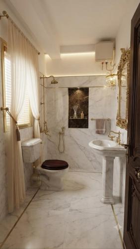a bathroom with a toilet and a sink at Hotel Coral Shade's in Mahabalipuram