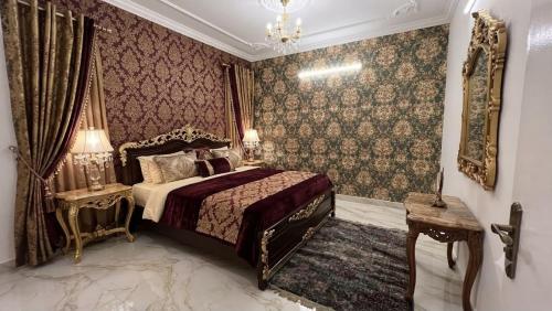 a bedroom with a bed and a chandelier at Hotel Coral Shade's in Mahabalipuram