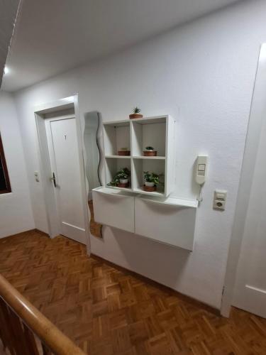 a room with white shelves on a white wall at GR ooms-Rents in Gemmrigheim