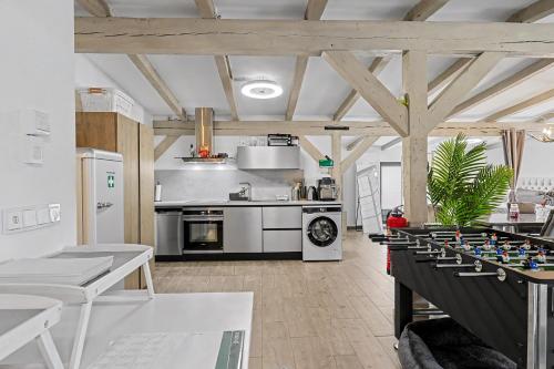 a large kitchen with a table and a chess board at Golden Grey Loft Bahrenfeld Volkspark Hamburg in Hamburg