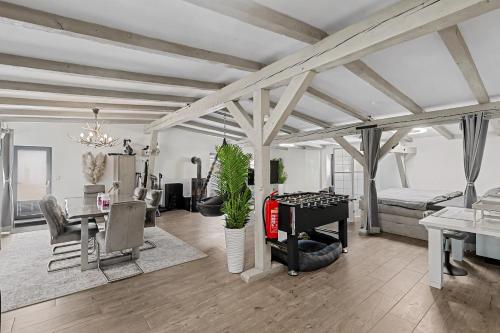a living room with a table and a bed at Golden Grey Loft Bahrenfeld Volkspark Hamburg in Hamburg