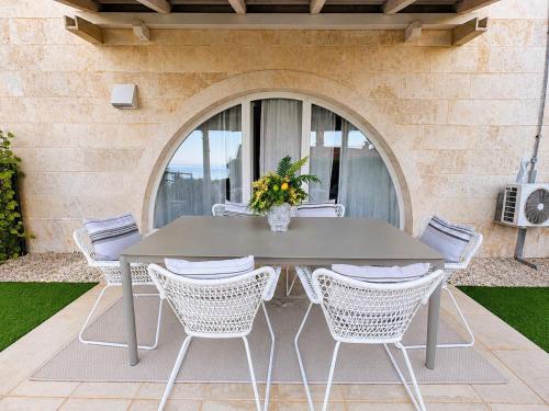 a gray table and chairs on a patio at Vila Ester - apartman Lovrana in Lovran