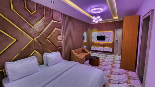 a hotel room with a bed and a tv at Oak Haven Lodging & Suites in Sagamu