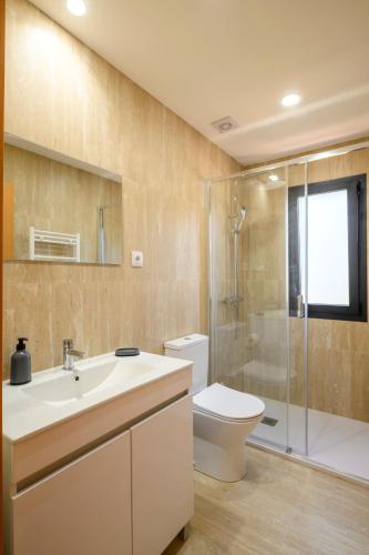 a bathroom with a sink and a toilet and a shower at Terreiro da Serra in Rio Caldo