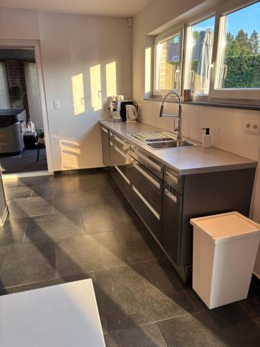 a kitchen with a sink and a counter at Maison des W in Jalhay