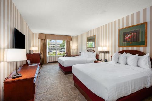 a hotel room with two beds and a television at Bayshore Resort in Traverse City