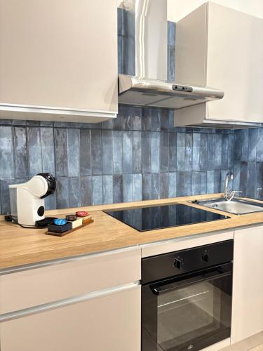 a kitchen with white cabinets and a sink at Bassa Marea in Nettuno