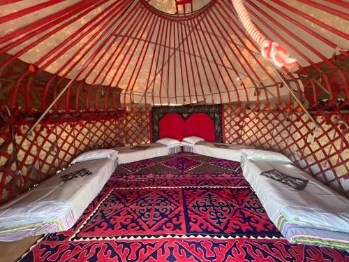 a bedroom in a yurt with two beds in it at Mars Canyon Yurt Camp in Tong