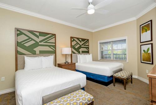 a hotel room with two beds and a window at WorldMark Reunion in Kissimmee