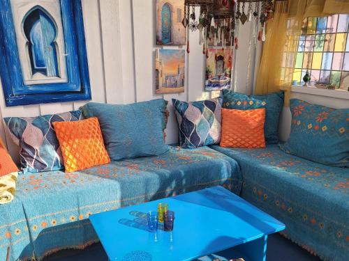 a living room with blue couches and a table at Casa Peace in Mysen