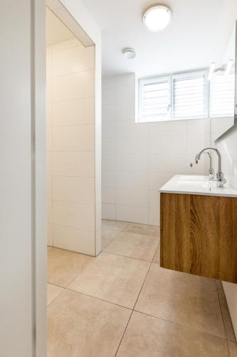 a bathroom with a sink and a mirror at Group accommodation 123 in Valkenburg