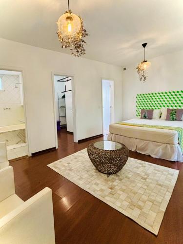 a room with two beds and a coffee table in it at Les Jardins de Rio in Rio de Janeiro