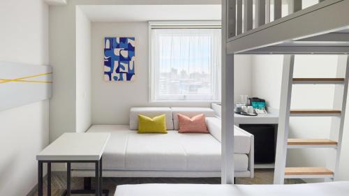 a small room with a bed and a desk at Holiday Inn Express Sapporo Susukino by IHG in Sapporo