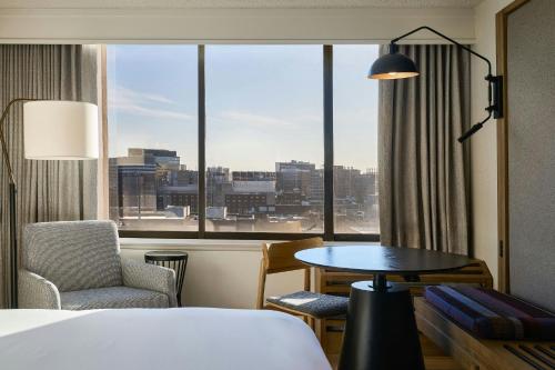 a hotel room with a bed and a table and a window at Sheraton Philadelphia University City Hotel in Philadelphia