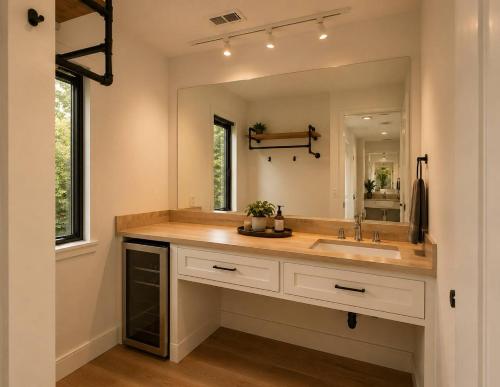 a bathroom with a sink and a large mirror at Fall Hideaway - VailsBluff - Romantic Escape in Broken Bow