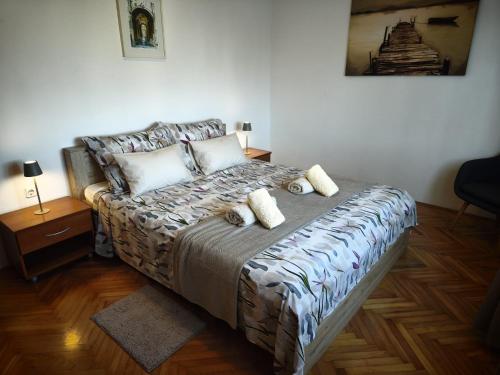 a bedroom with a bed with two pillows on it at Apartman Ivona in Zadar
