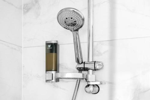 a shower with a shower head in a bathroom at Providence Suites 1 Bedroom Sleeps 4 Perfect for Contractors and Families and Solo Travellers in Fallings Park