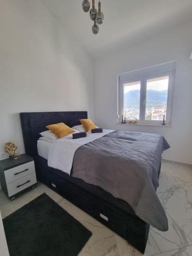 a bedroom with a large bed and a window at Sea you in Bar in Bjeliši