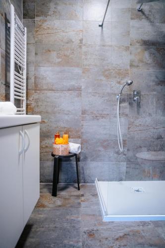 a bathroom with a shower and a sink at Infinity Apartman in Esztergom