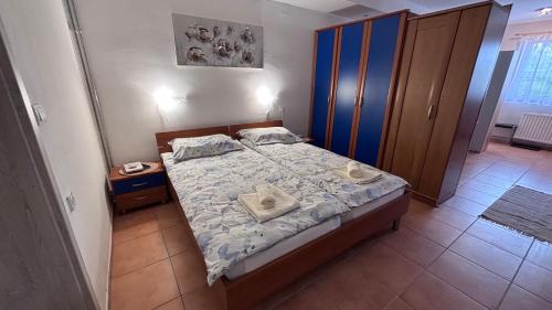 a bedroom with a bed with two pillows on it at Apartma Rožman in Radenci
